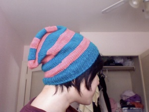 a stripy pink and turquoise hat 